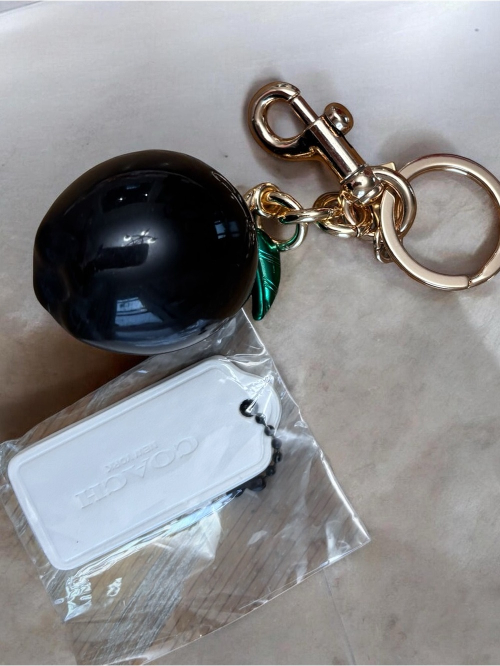 Black apple Keychain Charm with Gold Hardware and Green Leaf